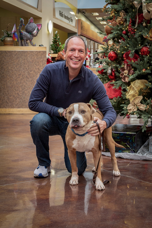 Brian with dog in front of Christmas Tree