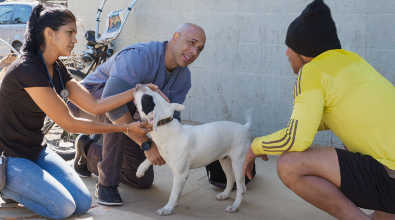 Stewart with man named Antonio and dog named Piglet